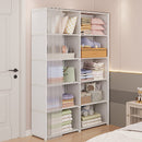 White storage cabinet with shelves filled with folded clothes and items in a room.
