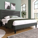 Bedroom with a gray upholstered bed, white bedding, and green blanket.