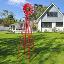 Garden pots, outdoor decor, garden ornaments, Red windmill in a garden with a house in the background