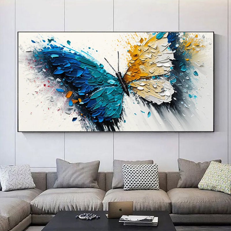 Abstract butterfly painting on a wall above a sofa