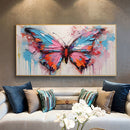 Colorful butterfly painting on a wall above a sofa with decorative pillows.