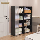 Black storage cabinet with shelves filled with folded clothes and pillows in a room.