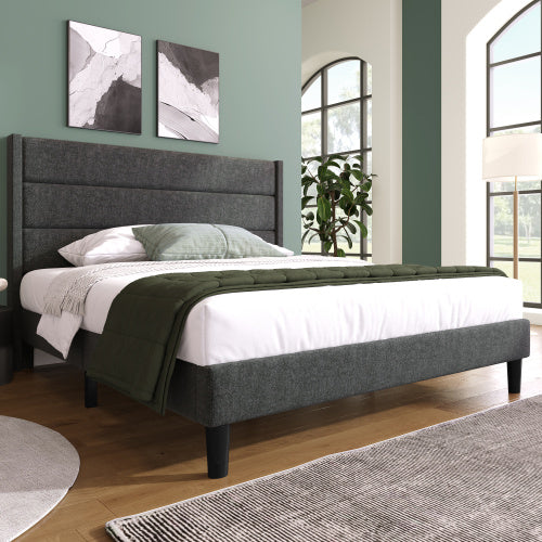 Bedroom with a gray upholstered bed, white bedding, and green blanket.