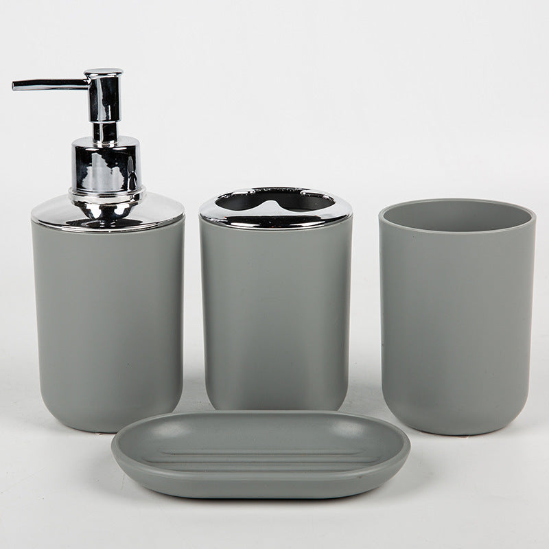 Household supplies, household cleaning products, cleaning products Gray bathroom accessory set with a dispenser, toothbrush holder, cup, and soap dish on a white background.