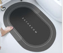 Mat, comforters, Gray bathmat with 'Bathroom' text on a white bathtub