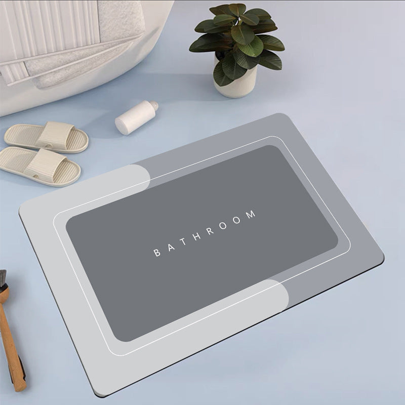 Mat, comforters, grey bathmat with 'Bathroom' text on a light blue surface with slippers and a plant.