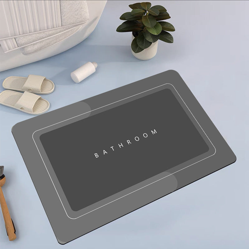 Mat, comforters, grey bathmat with 'Bathroom' text on a light blue surface with slippers and a plant.