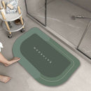 Mat, comforters, Green bathmat with 'Bathroom' text on a bathroom floor.