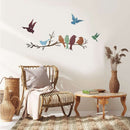 Home decor, room decor, wall decor, Living room with wicker chair, wooden table, and decorative wall stickers of birds on a branch.