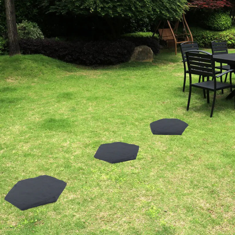 Garden pots, outdoor decor, garden ornaments, Black hexagonal mats on a grassy lawn with outdoor furniture in the background