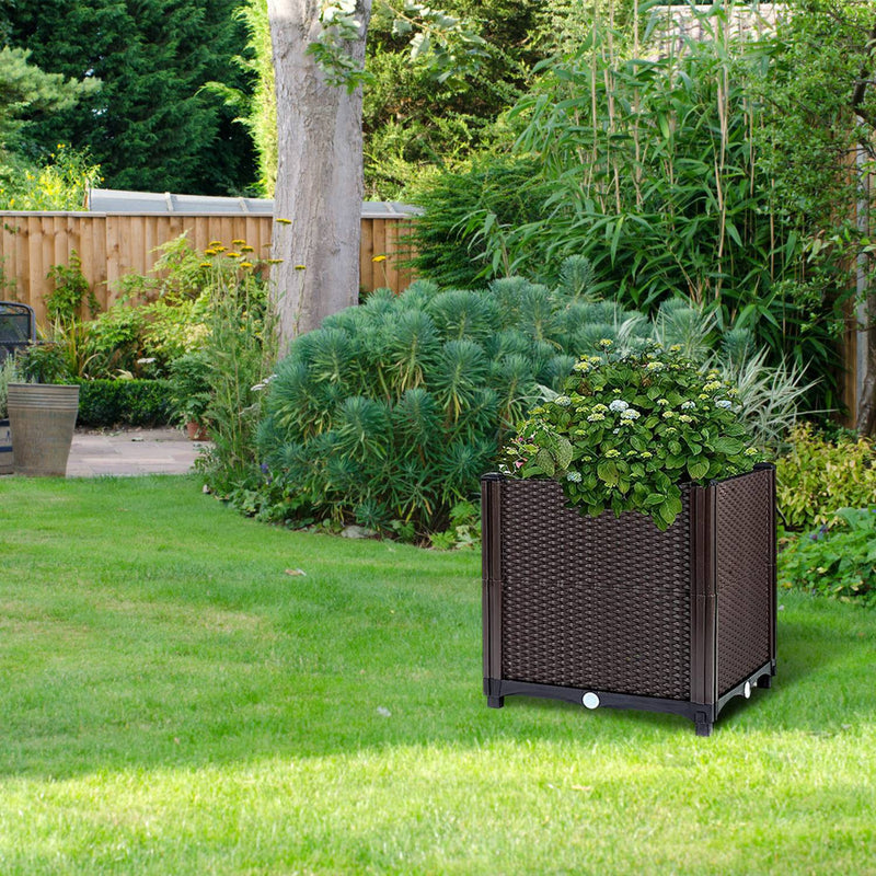 Garden pots, outdoor decor, garden ornaments, Wicker planter with plants on a grassy lawn