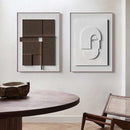 Home decor, room decor, wall decor, two abstract paintings on a wall with a table and chair in the foreground.