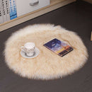 Mats, bed sheets, comforters, round beige rug on a dark floor with a cup, saucer, and book on top