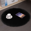 Mats, bed sheets, comforters, Black fluffy rug with a cup, saucer, and tablet on a dark surface.