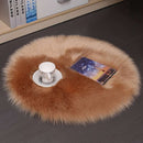 Mats, bed sheets, comforters, round brown fur rug on a dark floor with a cup and book on top