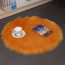 Mats, bed sheets, comforters, Round orange fur rug with a cup, saucer, and book on a dark surface.