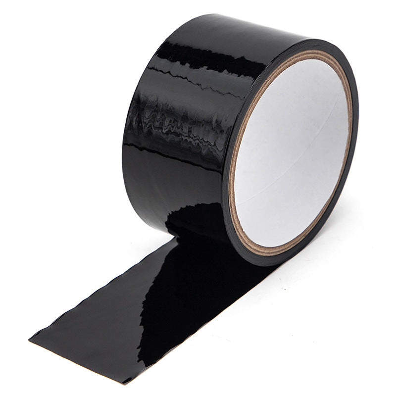 Household supplies, household cleaning products, cleaning products Roll of black tape on a white background