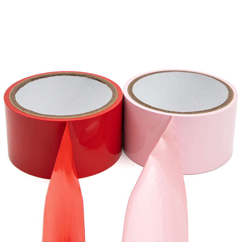 Household supplies, household cleaning products, cleaning products Two rolls of red and pink tape on a white background