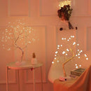 Home decor, room decor, Decorative LED trees with lights on small tables against a neutral wall.