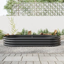Garden pots, outdoor decor, garden ornaments, Black metal raised garden bed on a gravel surface with a white lattice fence in the background.