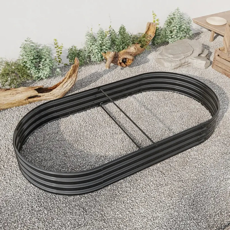 Garden pots, outdoor decor, garden ornaments, Black metal track on a sandy surface with decorative elements in the background