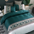 Mat, bed sheets, comforters, Teal bedding set with decorative pillows on a bed in a bedroom setting.