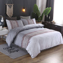 Mat, bed sheets, comforters, Neatly made bed with decorative bedding in a bedroom setting.