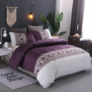 Mat, bed sheets, comforters, Bedroom with purple and white bedding, decorative pillows, and a plant.