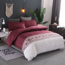 Mat, bed sheets, comforters, maroon bedding set on a bed in a bedroom with decorative elements.