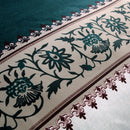 Mat, bed sheets, comforters, Decorative rug with floral patterns and intricate border design.