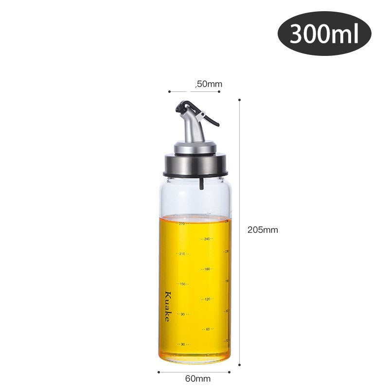 Household supplies, household cleaning products, cleaning products Glass oil bottle with measurements and oil level indicator on a white background