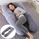 Comforters, bed sheets, mats, Woman lying on a large U-shaped grey body pillow in a bedroom setting.