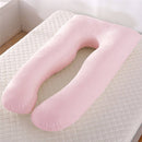 Comforters, bed sheets, mats, Pink U-shaped body pillow on a textured surface