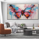 Living room with a large abstract butterfly painting on the wall.