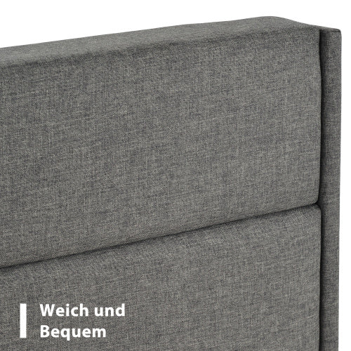 Gray upholstered headboard with text 'Weich und Bequem' on a white background