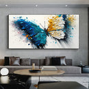 Modern living room with a large abstract butterfly painting on the wall.
